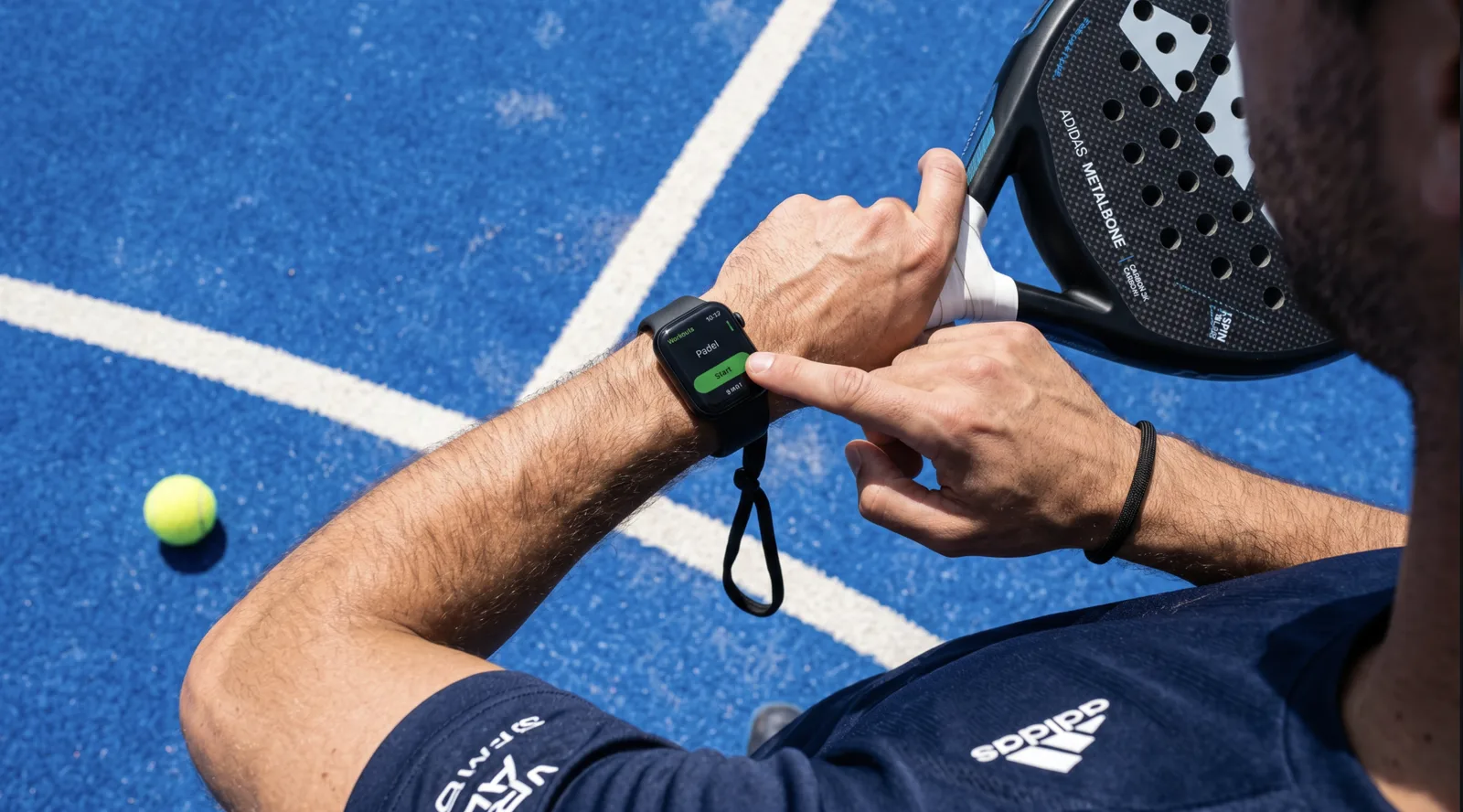 A player starting a PadelLabs session on Apple Watch while holding a padel racket